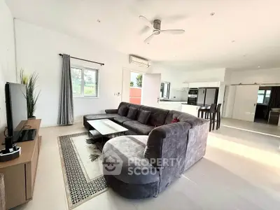 Spacious modern living room with open kitchen and stylish furniture