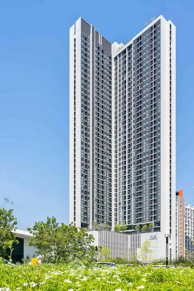 Stunning high-rise building with modern architecture and lush greenery.