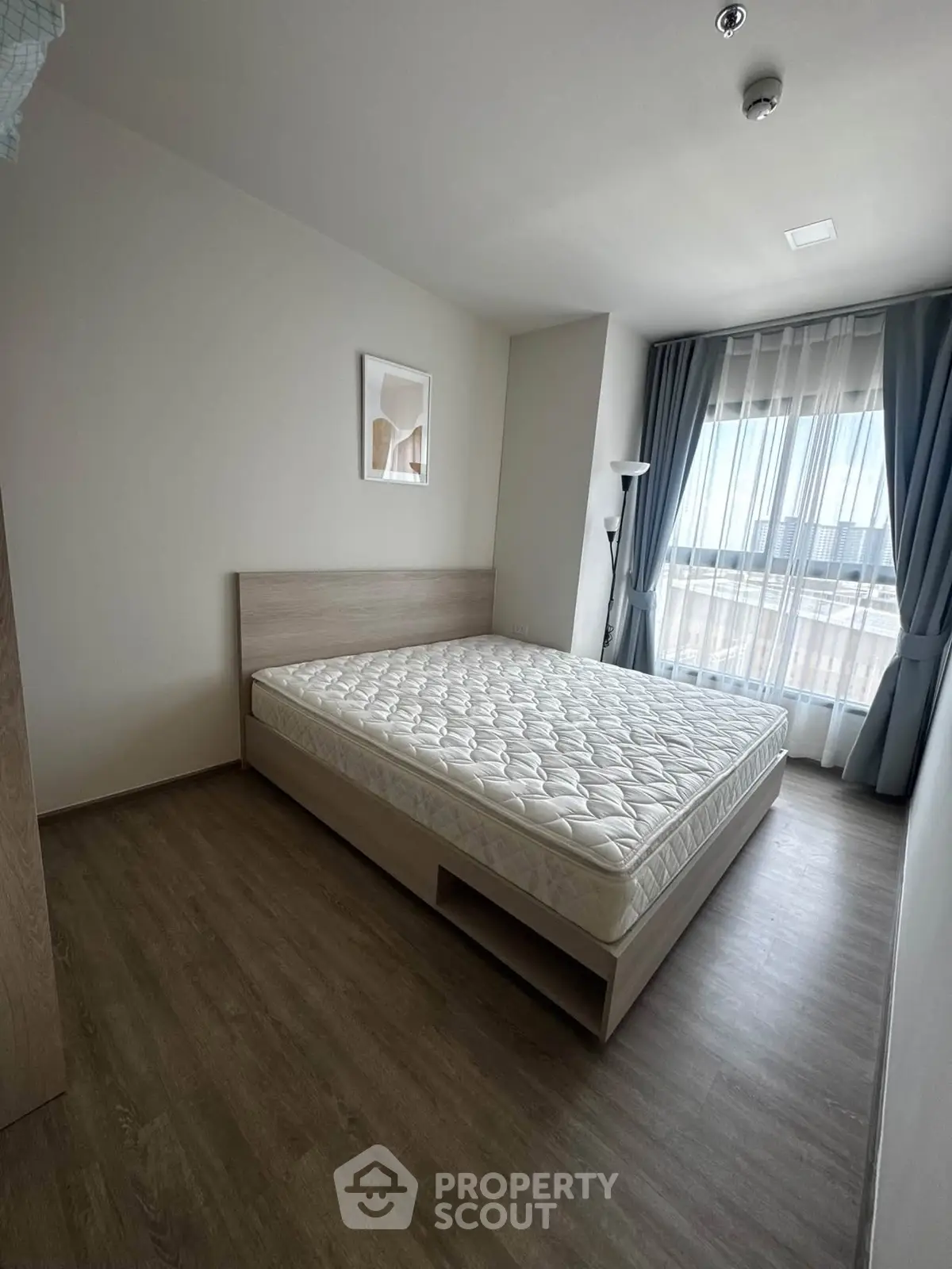 Modern bedroom with large window and minimalist decor
