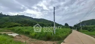 Scenic land plot with lush greenery and mountain views, ideal for development or investment.
