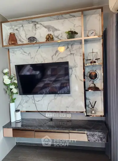 Luxurious living room with marble accent wall and modern TV setup, perfect for stylish urban living.