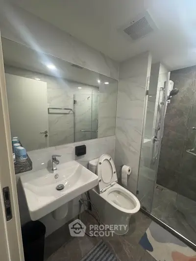 Modern bathroom with sleek fixtures and glass shower enclosure