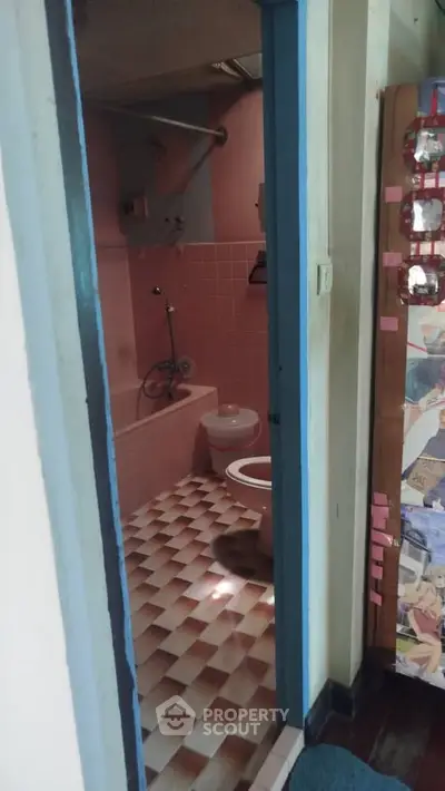 Charming vintage bathroom with pink tiles and classic fixtures