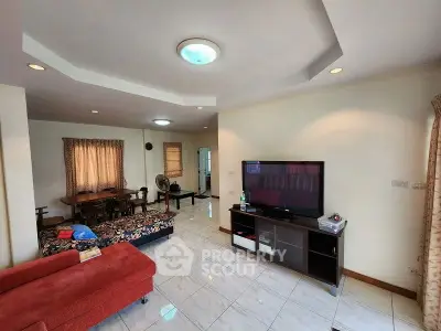 Spacious living room with modern decor and large TV unit