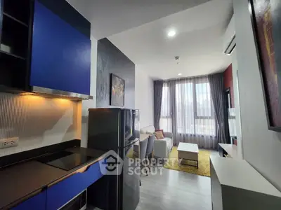 Modern open-layout living room with stylish kitchen and cozy seating area.