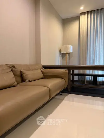 Modern living room with beige leather sofa and elegant floor lamp