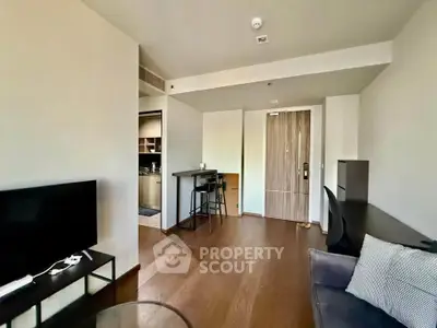 Modern living room with sleek furniture and open kitchen layout