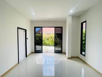 Spacious modern living room with large windows and garden view