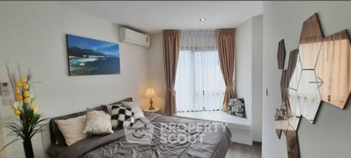 Modern bedroom with stylish decor and large window for natural light