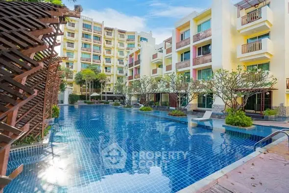 Luxurious apartment complex with stunning pool and modern architecture.