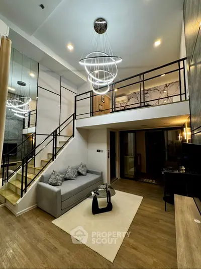 Modern loft-style living room with elegant lighting and mezzanine