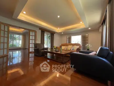 Spacious living room with elegant wooden flooring and cozy seating area