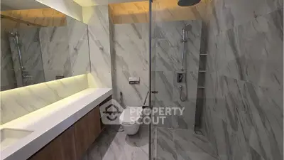 Luxurious modern bathroom with marble tiles and sleek fixtures