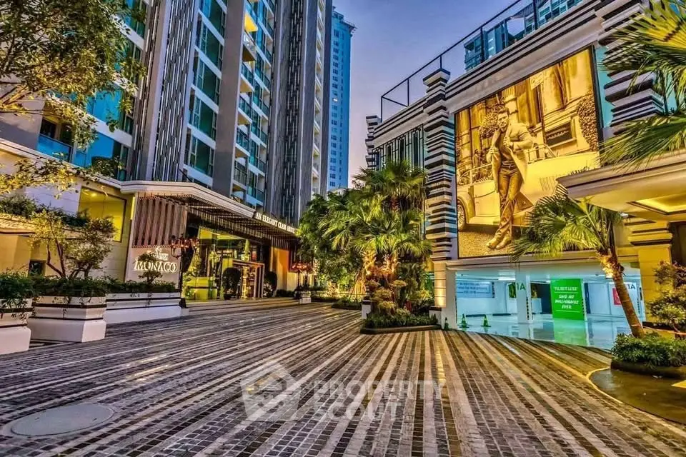 Luxurious condominium entrance with modern architecture and lush landscaping