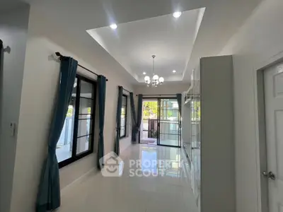 Spacious living room with elegant lighting and large windows for natural light.