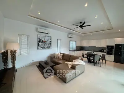 Spacious modern living room with open kitchen and stylish decor