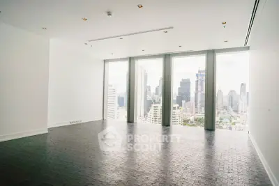 Spacious modern living room with panoramic city view and sleek flooring.