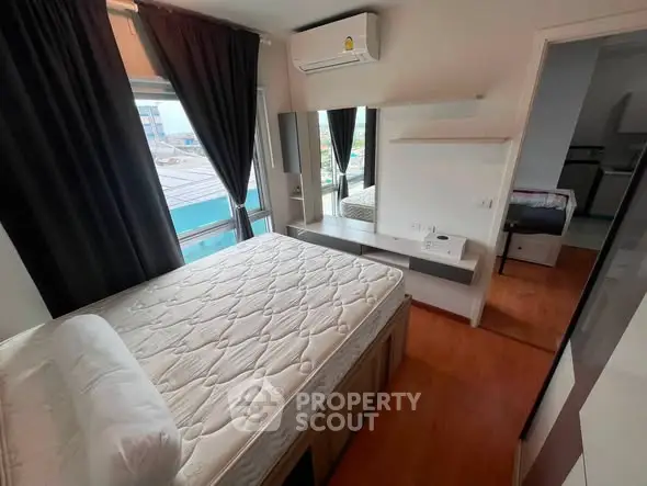 Modern bedroom with large windows and air conditioning in a stylish apartment.