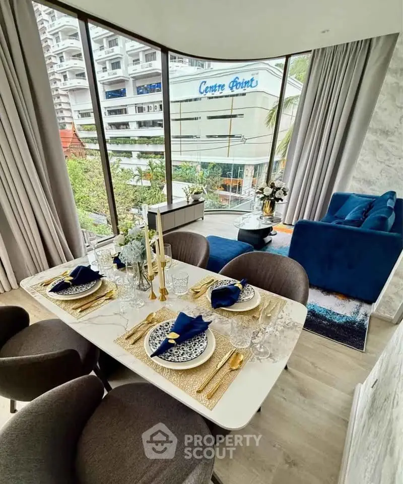Luxurious modern living room with elegant dining area and stunning city view.