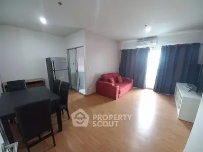 Spacious living room with modern furniture and natural light, perfect for relaxation and entertainment.