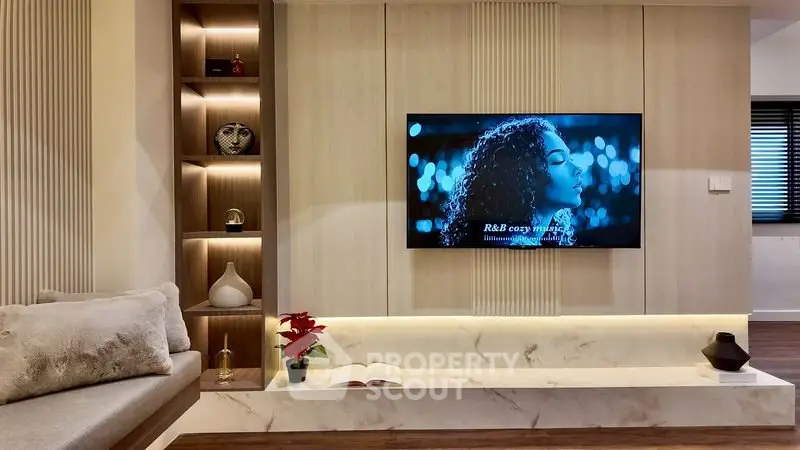 Modern living room with built-in TV and cozy seating area.
