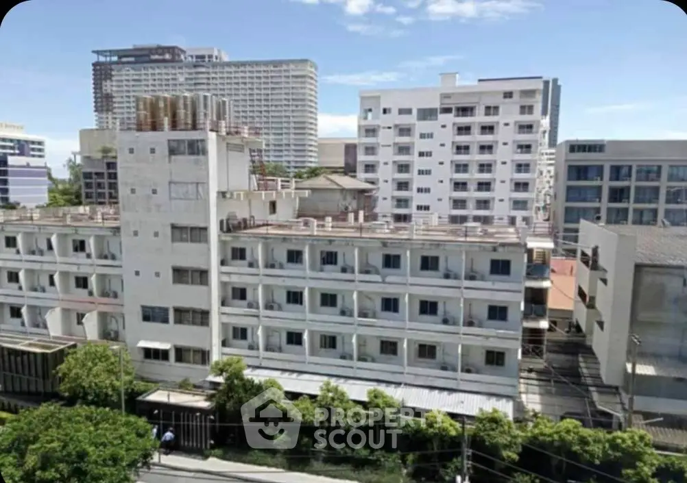 Urban apartment buildings with clear blue sky, showcasing city living.