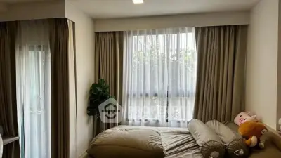 Cozy bedroom with large windows and plush bedding in modern apartment.