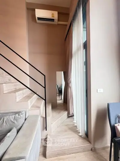 Modern duplex apartment with stylish staircase and large windows