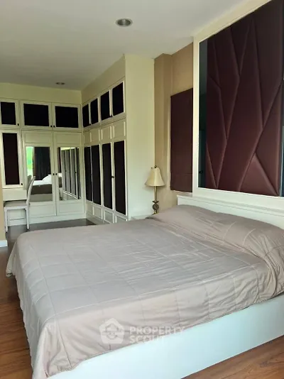 Spacious bedroom with elegant built-in wardrobes and cozy lighting