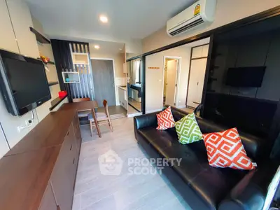 Modern living room with sleek furniture and vibrant pillows in a stylish apartment.