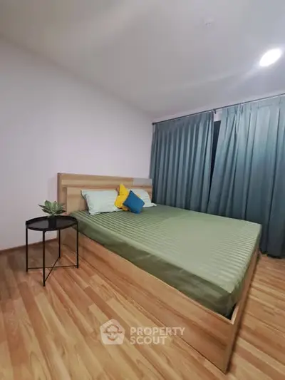 Cozy bedroom with modern wooden flooring and stylish decor