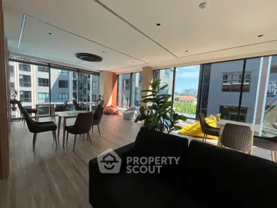 Spacious modern living room with large windows and stylish furniture