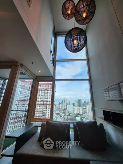 Stunning high-rise living room with floor-to-ceiling windows and city skyline view.