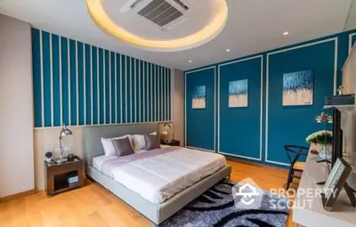 Modern bedroom with stylish blue accent wall and cozy lighting