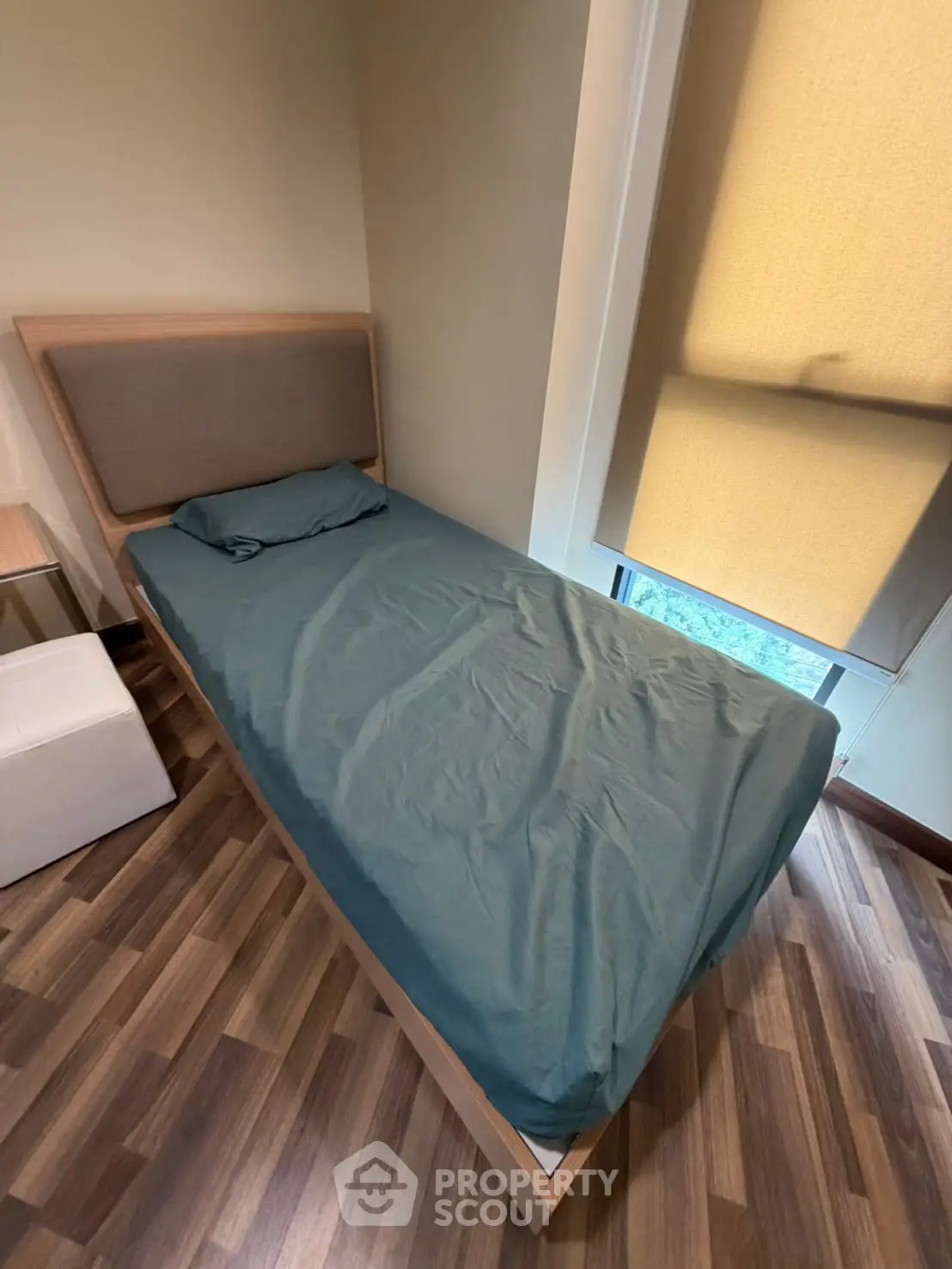 Cozy bedroom with single bed and modern decor, perfect for a comfortable living space.