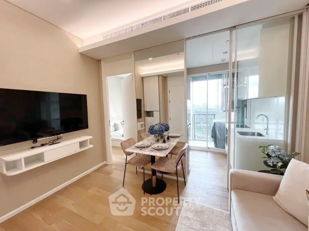 Modern living room with dining area and kitchen, featuring sleek design and natural light.