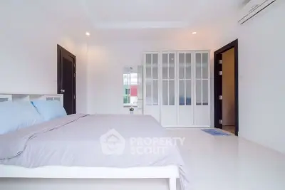 Spacious modern bedroom with sleek design and ample natural light