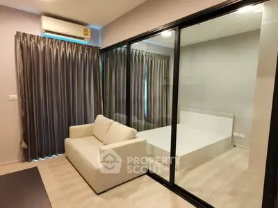 Modern apartment with glass partition separating living room and bedroom