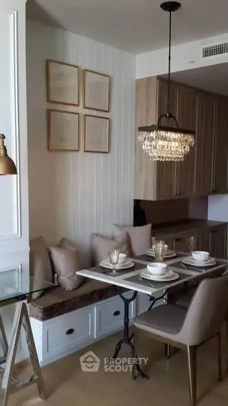 Chic dining area with elegant chandelier and cozy seating in modern apartment