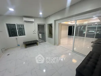 Spacious modern living room with marble flooring and large glass doors