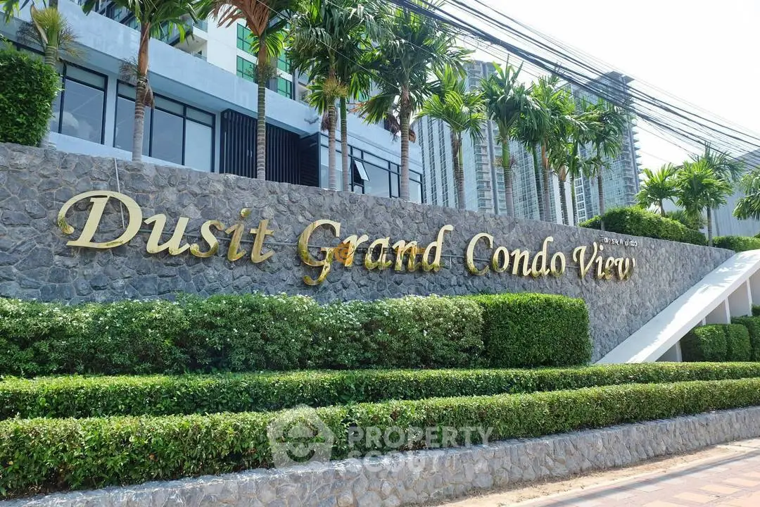 Luxurious Dusit Grand Condo View entrance with lush greenery and modern architecture.