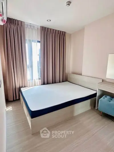 Modern bedroom with natural light and minimalist design in a stylish apartment.