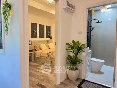 Charming interior view showcasing a cozy bedroom and modern bathroom with elegant decor.
