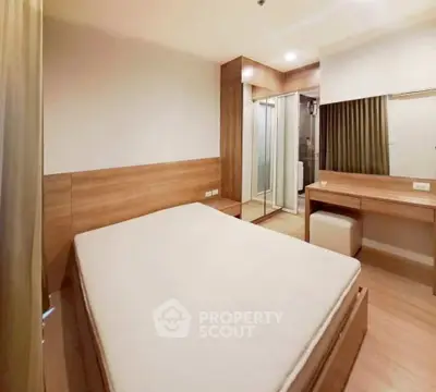 Modern bedroom with wooden accents and mirrored closet doors in a stylish apartment.