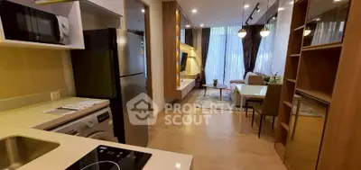 Modern open-plan kitchen and living room with stylish decor and large windows