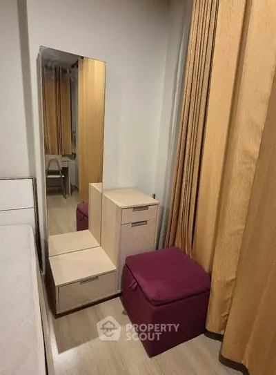 Cozy bedroom corner with mirror and storage solutions