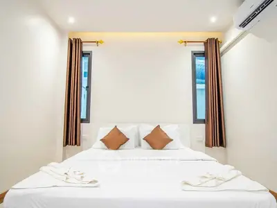 Modern bedroom with cozy double bed and elegant decor in a bright, airy space.