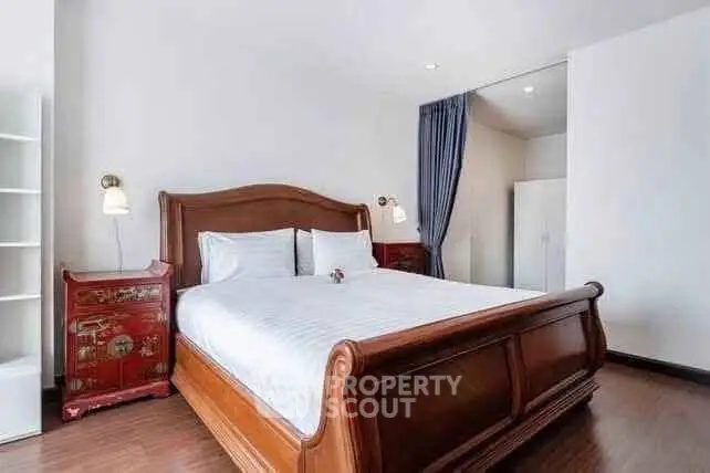 Elegant bedroom with wooden bed frame and stylish decor in modern apartment.