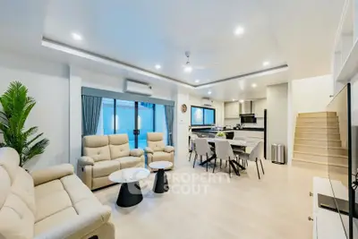 Spacious modern living room with open kitchen and elegant decor