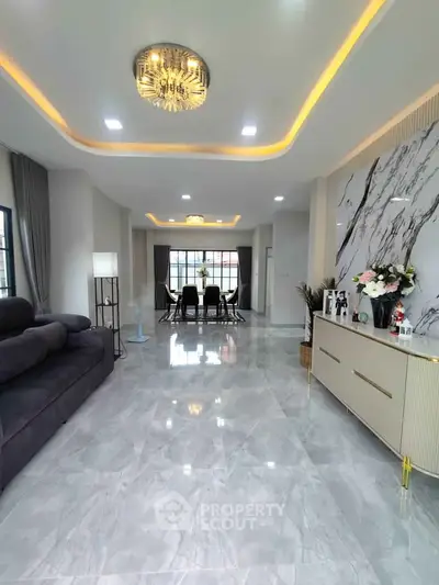 Luxurious open-plan living room with elegant marble flooring and modern lighting